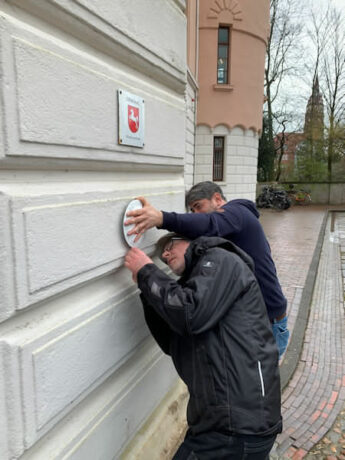 Anbringung des Museumsgütesiegels am rechten Torhaus vor dem Schloss.